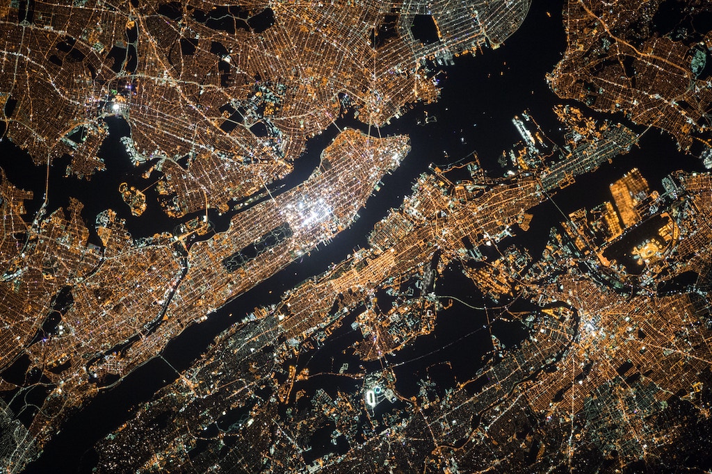 An image of Manhattan at night, shot from the atmosphere